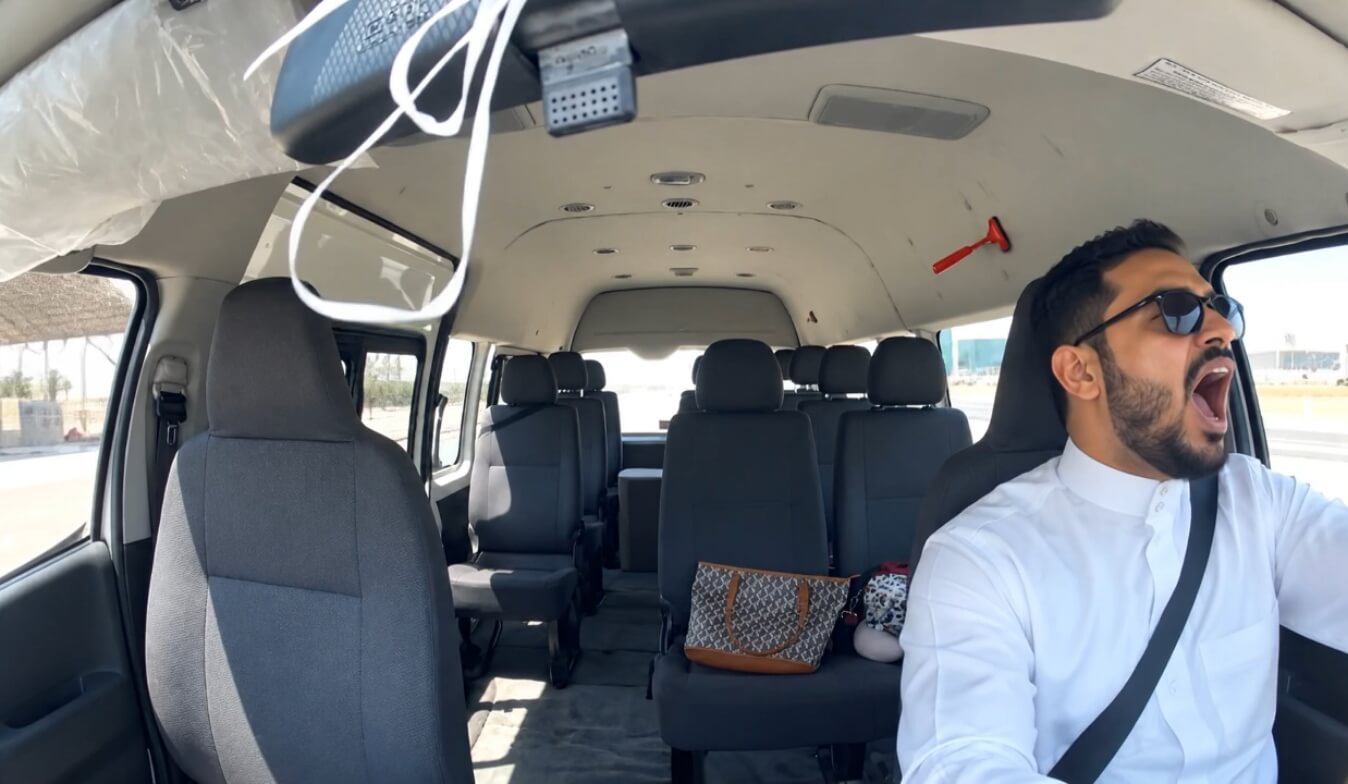 Van driver yawning at the wheel, showing signs of fatigue